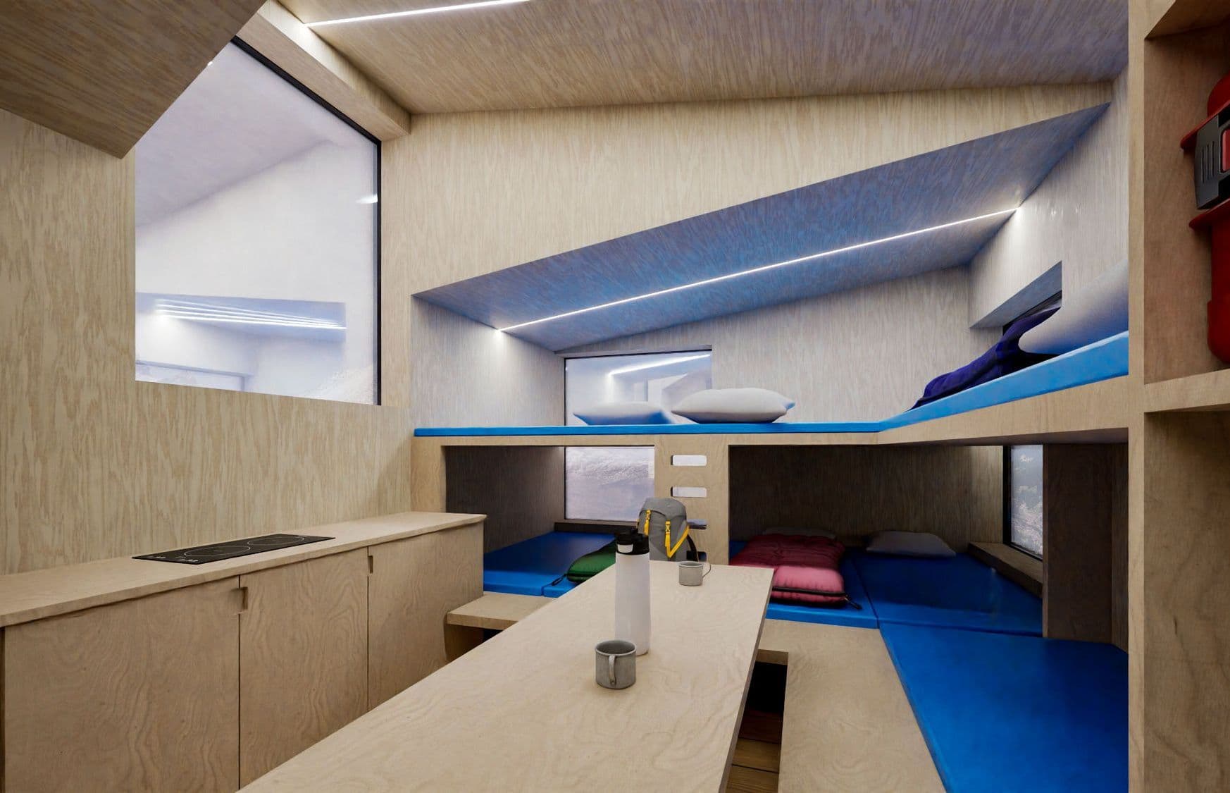 Mountain Guardian: interno del bivacco con rivestimenti in legno e cuccette blu